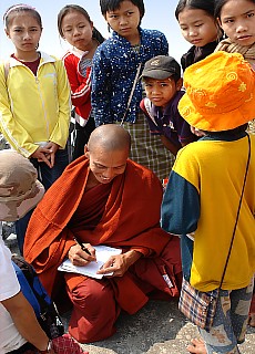 Monk with his school class on the summit of Mount Zwekabin