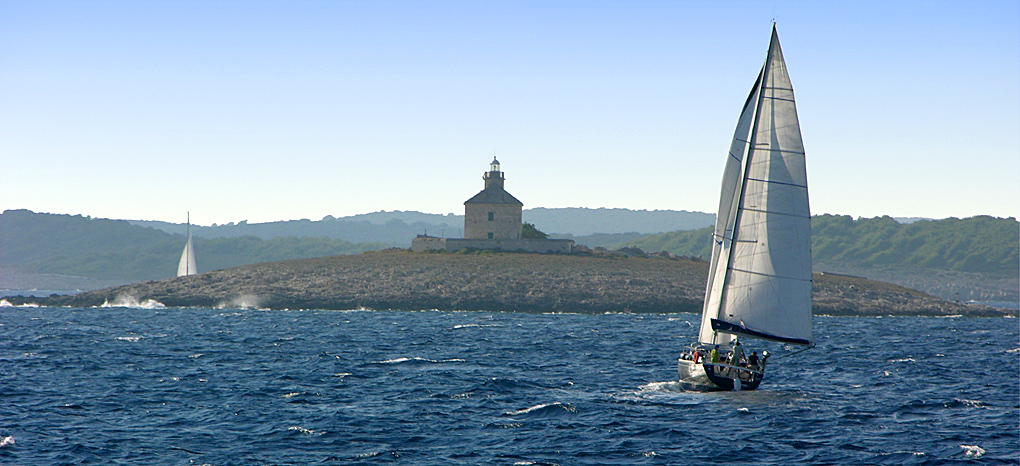 Sailing hard on the wind in front of islands world of Hvar