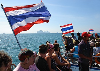 Three scheduled ferry boats are going lengthside to change over passengers direct on the open sea