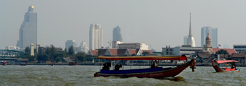 Boattrip on the Klongs of Thonburi, in the background Skyline of Bangkok