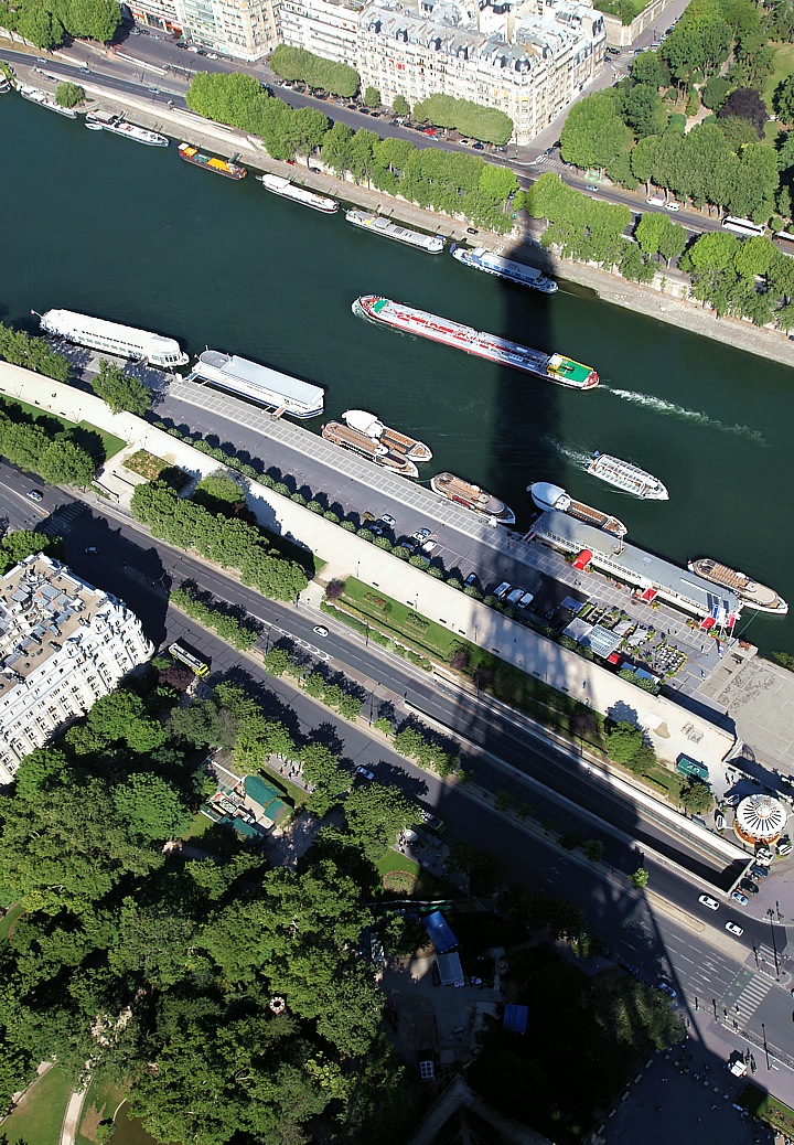 The Eiffel Tower throws its shadow on the river Seine