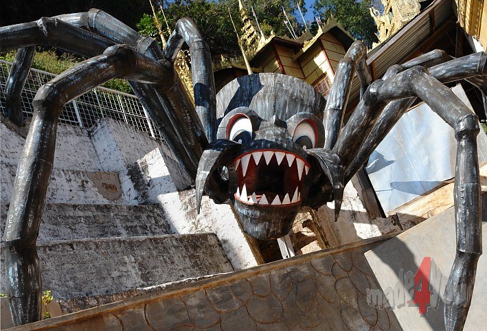 Giant Spider guards the entrance of flowstone cave Pindaya