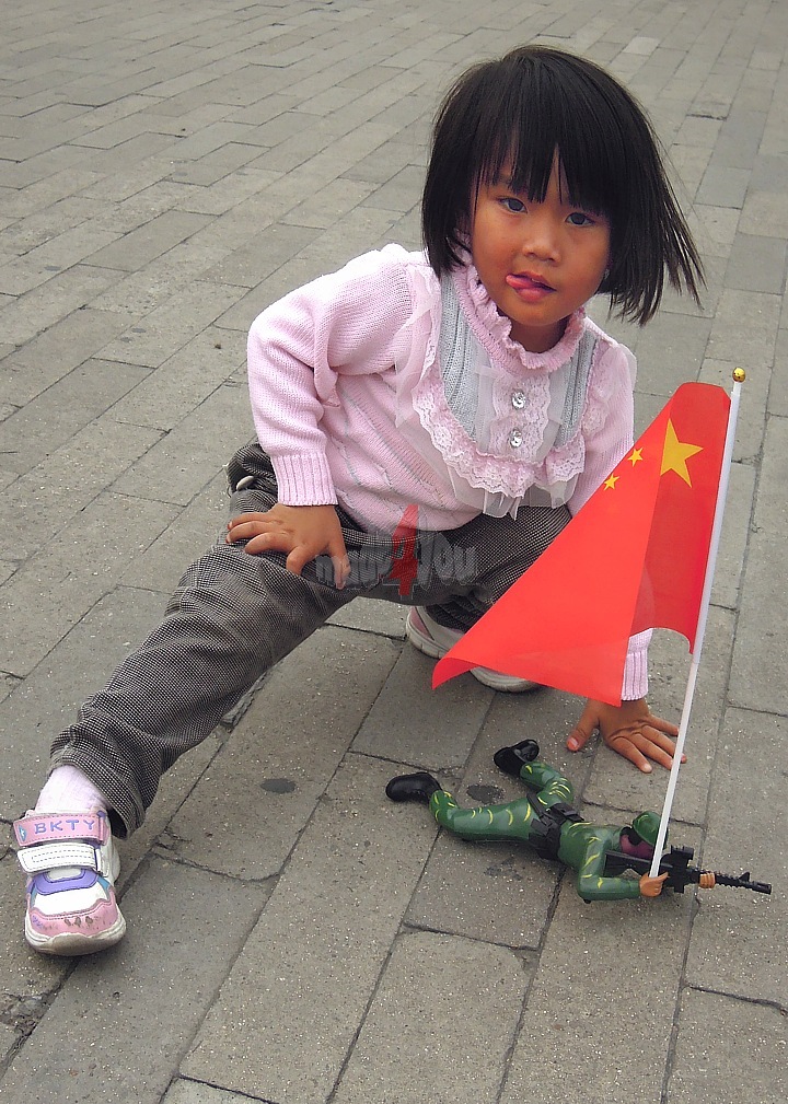 Child with military toys on Tiananmen Square