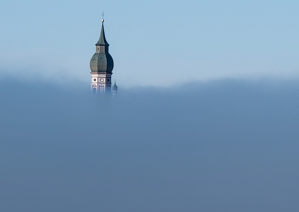 Lookout from moraine hill downto Monastery Andechs covered in fog