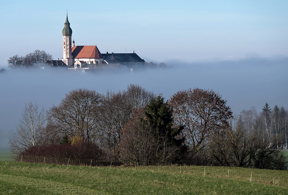 View from moraine hill downto Monastery Andechs covered in fog