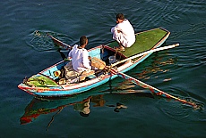 Fishermen with rowboat on the river Nile near Assuan