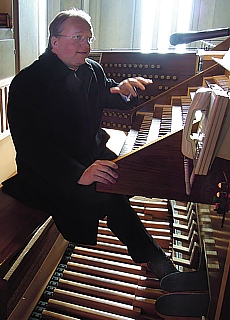 Pastor playing carillon at the tower tour of Mariahilf church