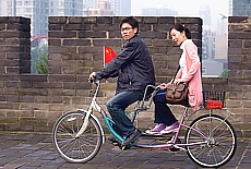 Tandem bicycle driver on the ancient city wall of Xian