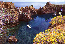 Cala Junco coastline on Panarea with Sailing boates