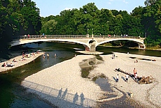 Gravel banks and cable bridge over the river Isar near the Public Baths