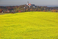 Monastery Andex upon yellow Canola field