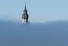 Lookout from moraine hill downto Monastery Andechs covered in fog