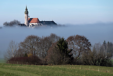 View from moraine hill downto Monastery Andechs covered in fog