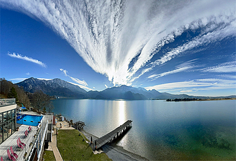 Magic sky and clouds like a volcanic eruption over lake Kochel