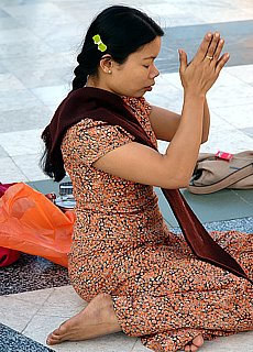 Young burmese girl praying