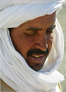 Arabian gay with turban in the sand dunes of Merzouga