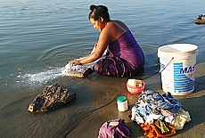Burmese woman washes her clothes in Ayeyarwady river