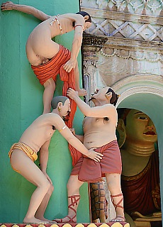 Adult sculptures in Shwebataung under the strict eyes of Buddha
