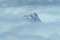 Snow covered Mount Aspiring in clowds