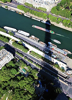 The Eiffel Tower throws its shadow on the river Seine